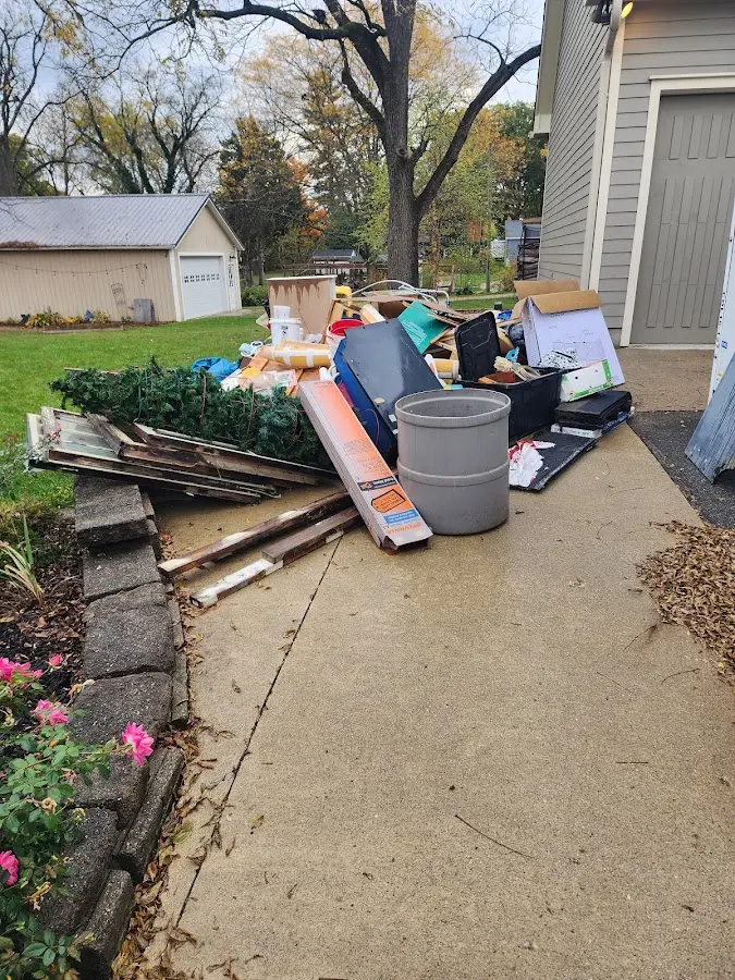 Dumpster being loaded with debris for Commercial Dumpster Rental in Kirkwood